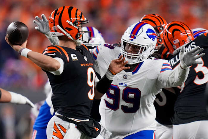 Cincinnati Bengals quarterback Joe Burrow (9) throws under pressure from Buffalo Bills defensive tackle Tim Settle (99). © Sam Greene/The Enquirer / USA TODAY NETWORK
